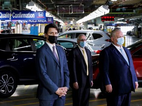 Canada's Prime Minister Justin Trudeau, Ontario's Minister of Economic Development Vic Fideli, and Ontario Premier Doug Ford stand during a news conference as they visit the production facilities of Honda Canada Manufacturing in Alliston, Ont., on Wednesday, March 16, 2022.