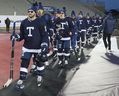 Alex Kerfoot leads the Maple Leafs onto the ice at Tim Hortons Field on Saturday.  The Leafs will face the Buffalo Sabers in the Heritage Classic on Sunday.