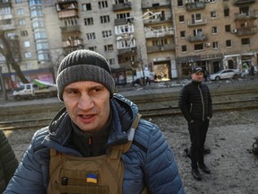 Kyiv's mayor Vitali Klitschko walks in front of a destroyed apartment building, in Kyiv on March 14, 2022.