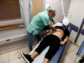 A patient suffering from long COVID is examined in the post-COVID-19 clinic of Ichilov Hospital in Tel Aviv, Israel, Feb.  21, 2022.