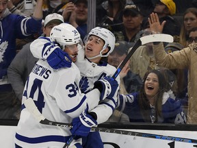 Maple Leafs' Auston Matthews (left) congratulates teammate Mitch Marner after Marner scored against the Bruins during the second period at TD Garden in Boston on Tuesday, March 29, 2022.