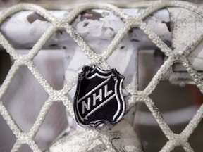 In this file photo taken Sept. 17, 2012, the NHL logo is seen on a goal at a Nashville Predators practice rink in Nashville, Tenn.