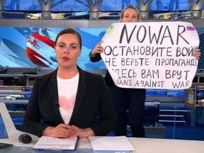 This video grab taken on March 15, 2022 shows Russian Channel One editor Marina Ovsyannikova holding a poster reading " Stop the war. Don't believe the propaganda. Here they are lying to you."