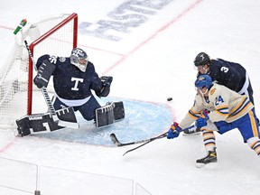 Maple Leafs goalie Petr Mrazek makes a save as Leafs defenceman Justin Holl covers Buffalo Sabres' Dylan Cozens during the first period of the Heritage Classic at Tim Hortons Field in Hamilton on Sunday, March 13, 2022.