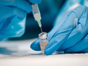 In this file photo taken on Nov. 24, 2021 a nurse prepares the Pfizer-BioNTech Covid-19 vaccine for children for distribution in Montreal.