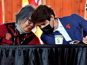 Prime Minister Justin Trudeau, right, and National Chief of the Assembly of First Nations RoseAnne Archibald at the Tk'emlups PowWow Arbour in Kamloops, British Columbia, October 18, 2021.
