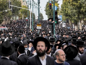Ultra-Orthodox Jewish mourners gather to attend the funeral of Haredi rabbi Chaim Kanievsky in the Israeli city of Bnei Brak near Tel Aviv, on March 20, 2022.