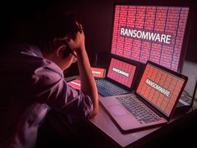 Young Asian male frustrated by ransomware cyber attack