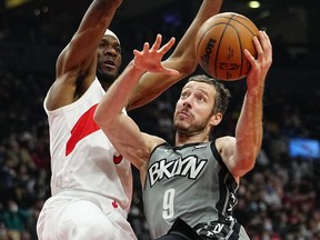 Brooklyn Nets guard Goran Dragic drives toward the basket while Toronto Raptors forward Precious Achiuwa defends during the first half at Scotiabank Arena on March 1, 2022.