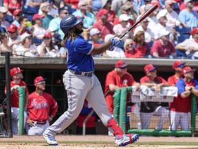 Vladimir Guerrero of the Toronto Blue Jays watches the ball leave the park after hitting a solo home run in the first inning against the Philadelphia Phillies in a Spring Training game at BayCare Ballpark on March 19, 2022 in Clearwater, Florida.