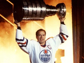 Edmonton Oilers captain Mark Messier holds the Stanley Cup during a pregame ceremony at Northlands Coliseum in Edmonton on Oct. 6, 1990.