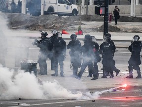 Police officers use tear gas next to the Colorado State Capitol as protests against the death of George Floyd continue for a third night on May 30, 2020 in Denver.