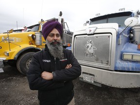 Jasvir Singh Dhaliwal, who runs his company Toosa Truck Lines Limited, is a member of the Ontario Dump Truck Association. He poses in his truck and in a yard full of 200 dump trucks on Dixie Rd.