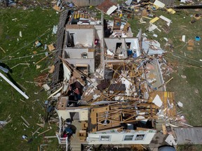 Residents sort through debris and belongings in a destroyed home in the aftermath of a tornado in the Arabi neighborhood of New Orleans, Louisiana, U.S., March 23, 2022. Picture taken with a drone. REUTERS/Adrees Latif