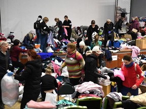 Volunteers pack clothes at a donation and distribution center in Lviv, Ukraine, Wednesday, March 2, 2022.