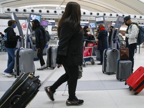 Travellers at Pearson International Airport on Friday March 11, 2022.