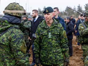 Gen. Wayne Donald Eyre, centre, Canadian chief of the Defence Staff (CDS) talks with soldiers during a visit of the Adazi military base, north east of Riga, Latvia, on March 8, 2022.