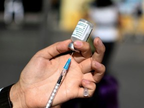 A nurse prepares a dose of the AstraZeneca vaccine against COVID-19, at a vaccination center at Paseo de la Sexta, in Guatemala City, on Feb. 25, 2022.