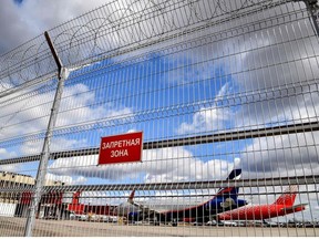 This file photo taken on April 04, 2020, shows an Aeroflot plane behind a fence at Moscow's Sheremetyevo airport. - Canada has closed its airspace to all Russian carriers in protest of the Russian invasion of Ukraine, Ottawa announced on February 27, 2022.