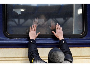 A man gestures in front of an evacuation train at Kyiv central train station on March 4, 2022.