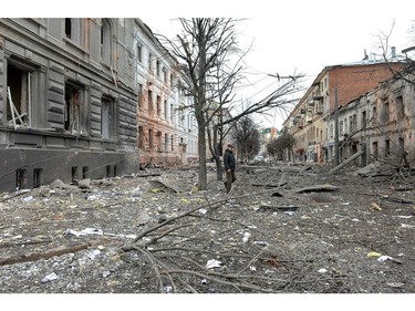 A pedestrian walks amid debris in a street following a shelling in Ukraine's second-biggest city of Kharkiv on March 7, 2022.