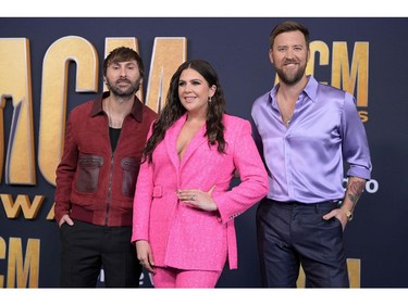 Lady A members Dave Haywood, left, Hillary Scott, centre, and Charles Kelley arrive for the 57th Academy of Country Music awards at the Allegiant stadium in Las Vegas, Nevada on March 7, 2022.