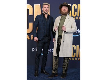 Brothers Osborne members T.J., left, and John Osborne arrive for the 57th Academy of Country Music awards at the Allegiant stadium in Las Vegas, Nevada on March 7, 2022.
