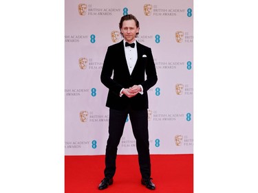 British actor Tom Hiddleston poses on the red carpet upon arrival at the BAFTA British Academy Film Awards at the Royal Albert Hall, in London, on March 13, 2022.