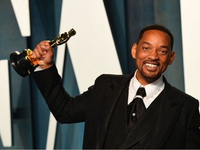 US actor Will Smith holds his award for Best Actor in a Leading Role for "King Richard" as he attends the 2022 Vanity Fair Oscar Party following the 94th Oscars at the The Wallis Annenberg Center for the Performing Arts in Beverly Hills, California on March 27, 2022.