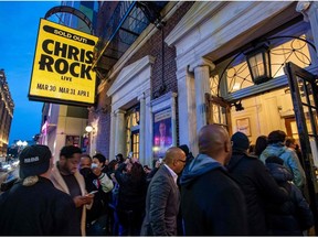 People enter the Wilbur Theatre for a sold out performance by US comedian Chris Rock in Boston, Massachusetts on March 30, 2022.