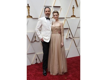 Canadian filmmaker Denis Villeneuve and guest pose on the red carpet during the Oscars arrivals at the 94th Academy Awards in Hollywood, Los Angeles, Calif., March 27, 2022.