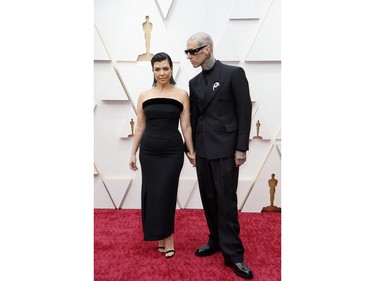 Kourtney Kardashian and Travis Barker pose on the red carpet during the Oscars arrivals at the 94th Academy Awards in Hollywood, Los Angeles, Calif., March 27, 2022.