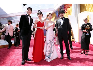 Sonia Yuan, Park Yu-rim, Jin Dae-yeon and Ahn Hwitae pose on the red carpet during the Oscars arrivals at the 94th Academy Awards in Hollywood, Los Angeles, Calif., March 27, 2022.
