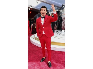 Simu Liu poses on the red carpet during the Oscars arrivals at the 94th Academy Awards in Hollywood, Los Angeles, Calif., March 27, 2022.