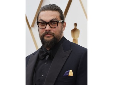 Jason Momoa wears a handkerchief in the colours of the Ukrainian flag in a show of solidarity for Ukraine as Russia's invasion of the country continues as he poses on the red carpet during the Oscars arrivals at the 94th Academy Awards in Hollywood, Los Angeles, Calif., March 27, 2022.