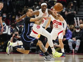 Orlando Magic guard Cole Anthony passes the ball as Toronto Raptors forward Precious Achiuwa defends during the first half at Scotiabank Arena.