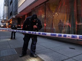 Members of the New York City Police Department (NYPD) search the area near the entrance of the Museum of Modern Art (MOMA) after an alleged multiple stabbing incident, in New York, U.S., March 12, 2022.
