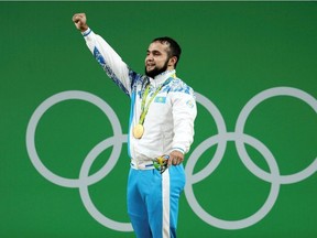 FILE PHOTO: 2016 Rio Olympics - Weightlifting - Victory Ceremony - Men's 77kg Victory Ceremony - Riocentro - Pavilion 2 - Rio de Janeiro, Brazil - 10/08/2016. Nijat Rahimov (KAZ) of Kazakhstan poses with his gold medal.