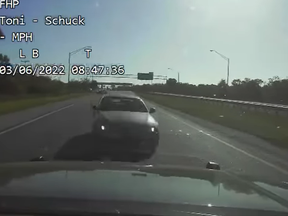 Screenshot of dash-cam footage of an alleged drunk driver about to hit a troopers vehicle head-on.