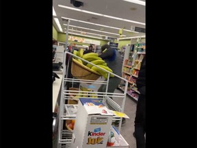 A screengrab of video posted by KGO-TV San Francisco journalist Dion Lim shows a thief throw bananas at a man who was recording the theft at a Walgreens in San Francisco.