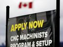 A hiring sign is seen in Edmonton on May 8, 2020.