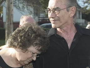 Marlene Truscott rests her head on Steven during a news conference outside their Guelph home on Thursday, Oct. 28, 2004.