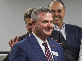 Toronto Mayor John Tory jokingly hides behind new TTC CEO Rick Leary at City Hall in Toronto, Ont. on Tuesday, July 10, 2018.