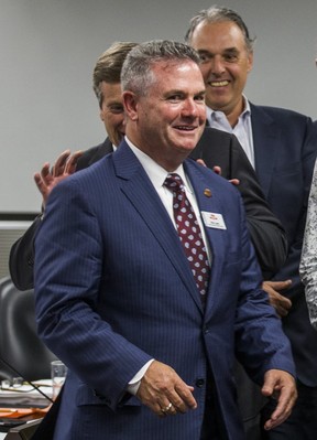 Toronto Mayor John Tory jokingly hides behind new TTC CEO Rick Leary at City Hall in Toronto, Ont. on Tuesday, July 10, 2018.