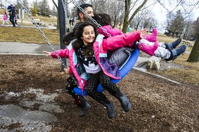 Feeling the breeze is Berlin with her dad Hamid and sister Rio on his lap. Mila swings at the back. The Nafar family enjoying the windy weather on Sunday, March 6, 2022.