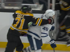 Boston Bruins forward Taylor Hall hits Maple Leafs defenceman Ilya Lyubushkin on March 29, 2022 in Boston.