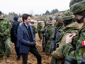 Canada's Prime minister Justin Trudeau talks with soldiers during a visit of the Adazi military base, north east of Riga, Latvia, on March 8, 2022.