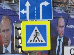 Boards with portraits of Russian President Vladimir Putin are seen on a street in Simferopol, Crimea March 11, 2022.