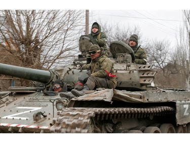 Service members of pro-Russian troops in uniforms without insignia are seen atop of a tank with the letter "Z" painted on its sides in the separatist-controlled settlement of Buhas (Bugas), as Russia's invasion of Ukraine continues, in the Donetsk region, Ukraine March 1, 2022.