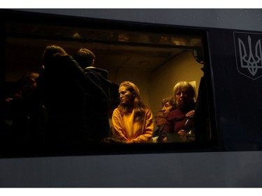 People are seen in an evacuation train from Kyiv to Lviv, at Kyiv central train station following Russia's invasion of Ukraine, in Kyiv, Ukraine March 1, 2022.